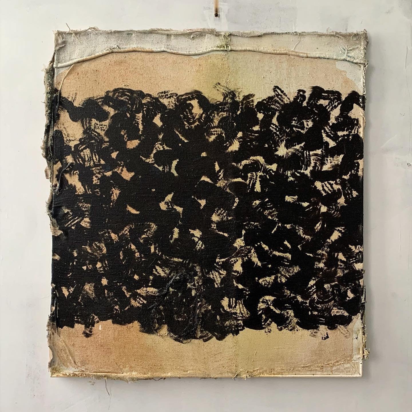 Mixed media artwork MM-B by Andrii Volkov showing dark organic charcoal forms against weathered canvas with raw textile edges